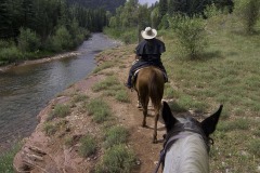 Riding with wrangler Michelle Bland of the Circle K Ranch, near the Dolores River, south of Rico, Colorado