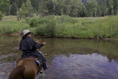 Riding with wrangler Michelle Bland of the Circle K Ranch, near the Dolores River, south of Rico, Colorado